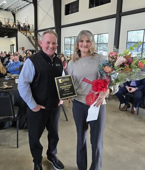 Deb Spencer accepting the Businesswoman of the Year Award plaque